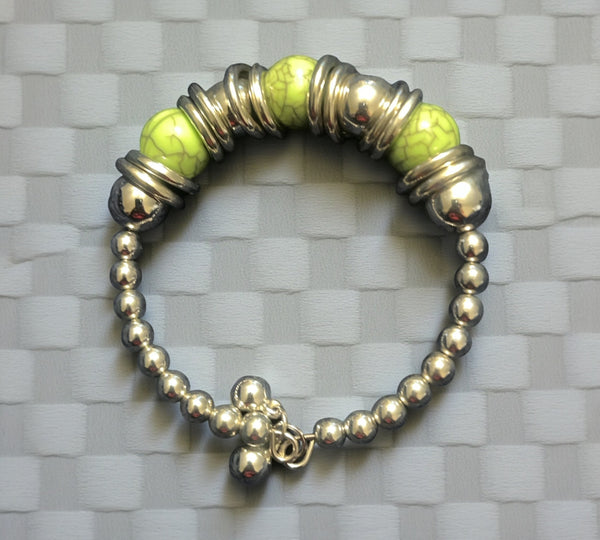 Silver stretch bracelet features a timeless, polished look with a pop of color at the center