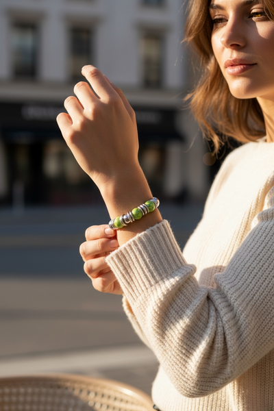 Silver stretch bracelet features a timeless, polished look with a pop of color at the center