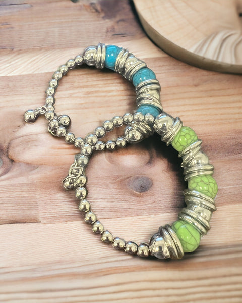 Silver stretch bracelet features a timeless, polished look with a pop of color at the center